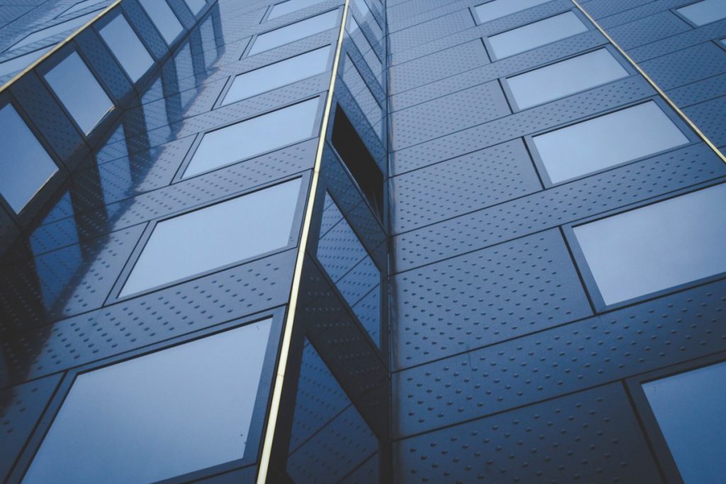 An outside view of a commercial building with windows tinted